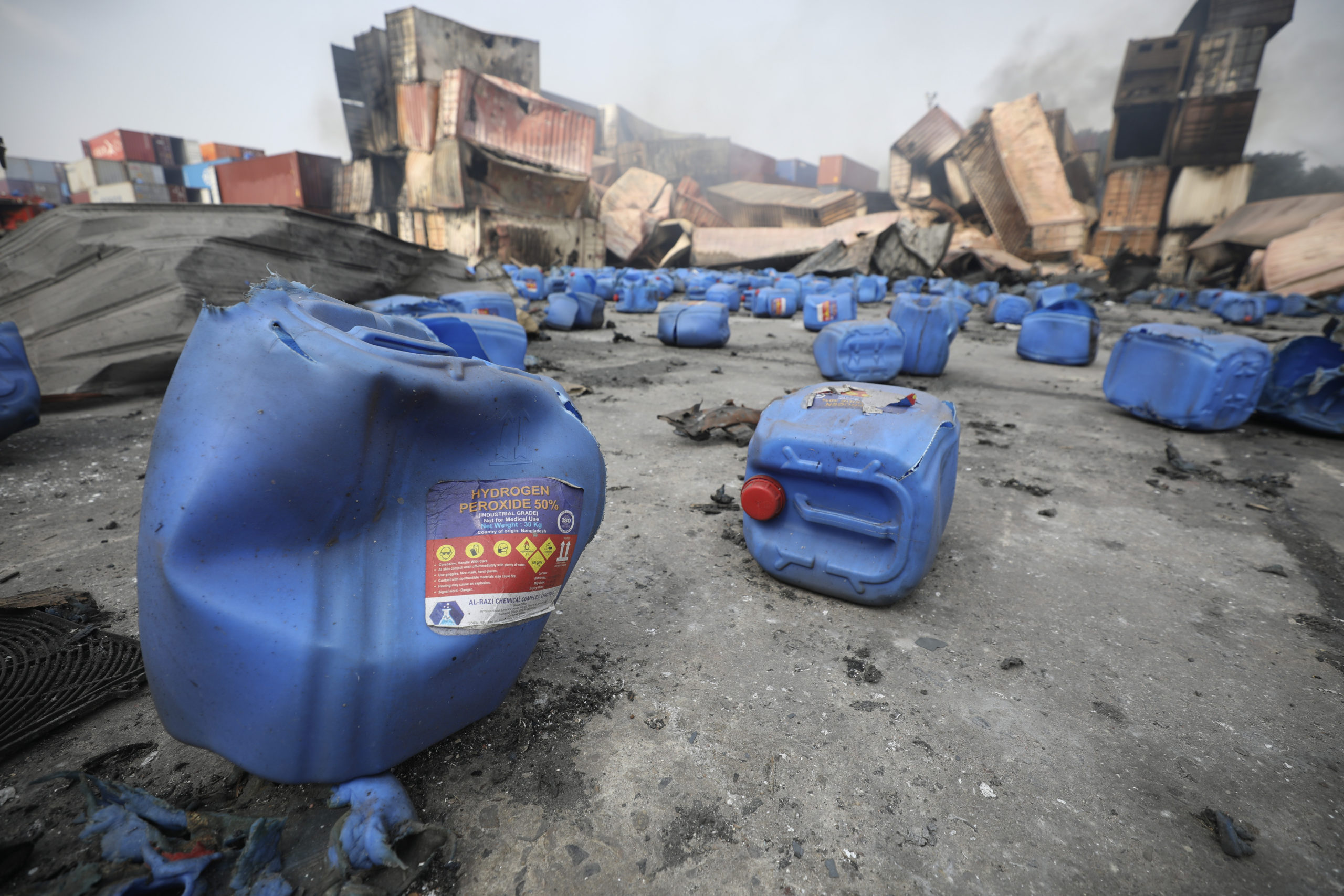 Containers of hydrogen peroxide, lie scattered after explosion at the BM Inland Container Depot