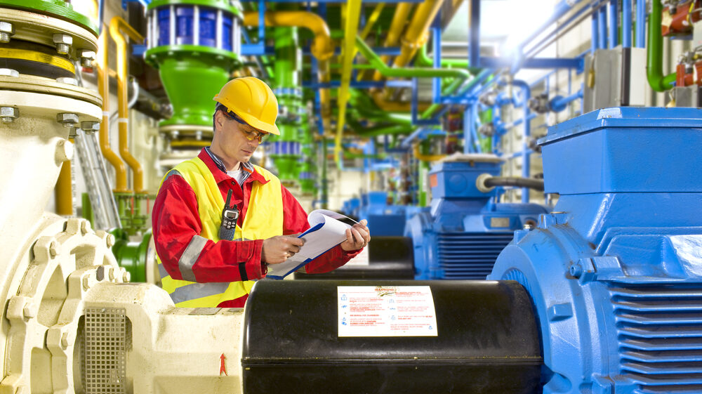 engineer-reviewing-checklist-in-manufacturing-plant