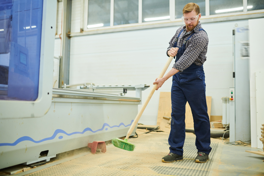 man-sweeping-wood-dust