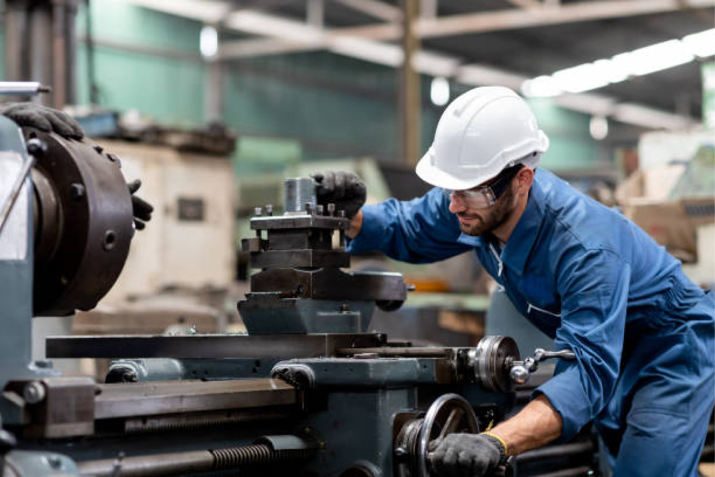 man-using-metal-machine-in-plant