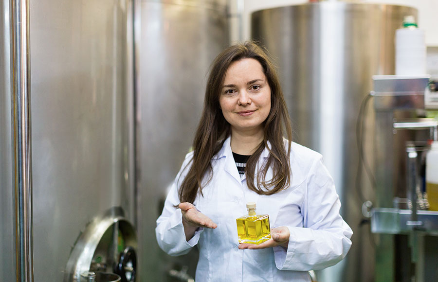 woman-holding-perfume-bottle-in-production-plant