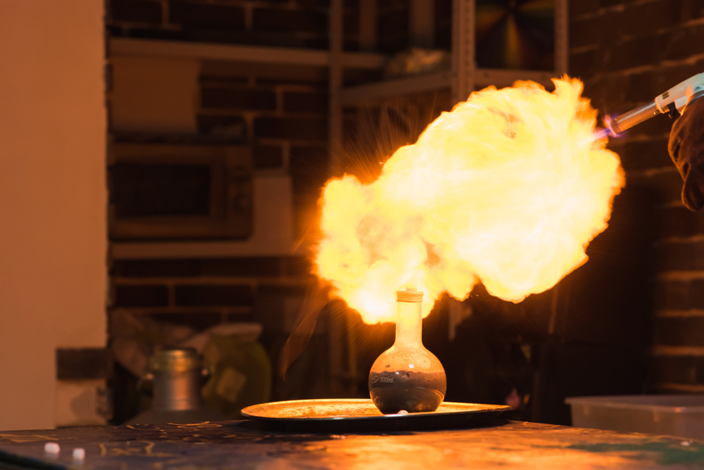 Lab technician setting controlled fire