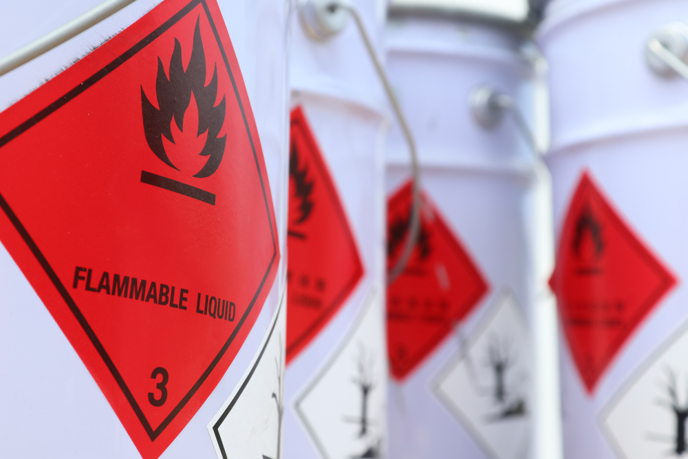 Containers of flammable liquid with warning signs